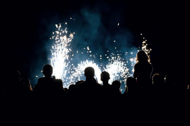 Parents and children watching fireworks on Bonfire Night