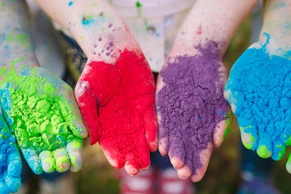 Kids with colourful paint powder in hands