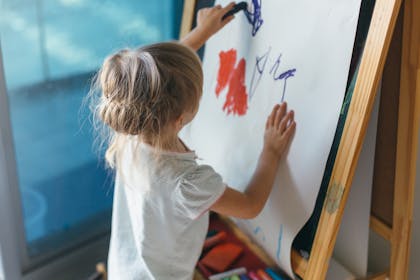 Child painting on an easel