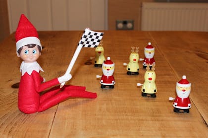 elf having santa and reindeer race 