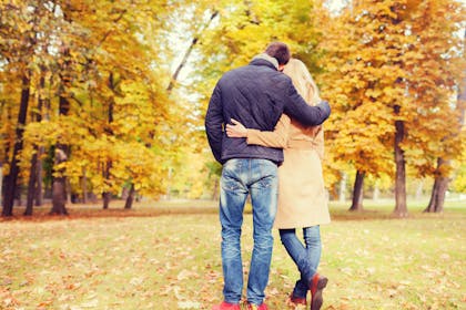 man and woman hugging in park