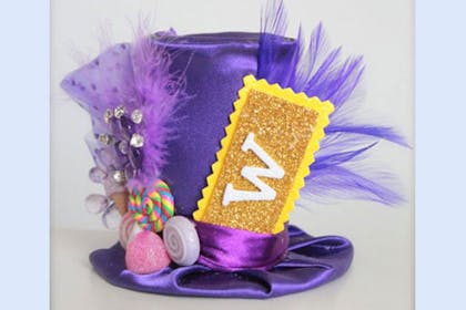 Willy Wonka purple top hat decorated with sweeties, feathers and a golden ticket