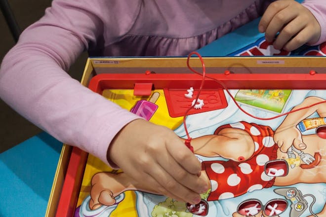 Kid playing the Operation board game