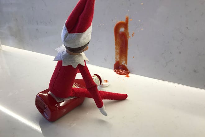 Christmas elf on the shelf squirts Ketchup on wall