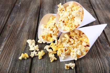 cones of popcorn on table