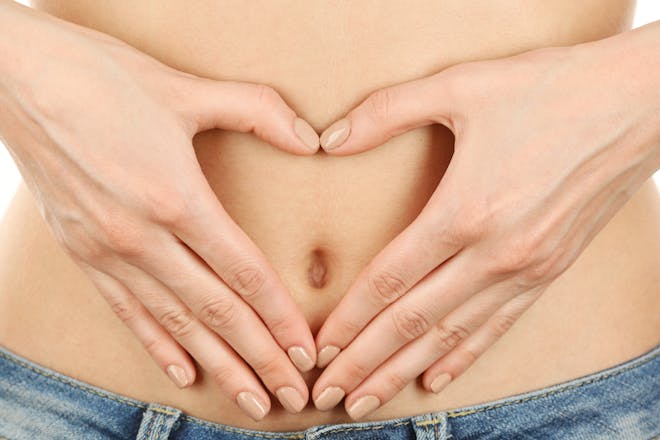 woman with hands in heart on stomach