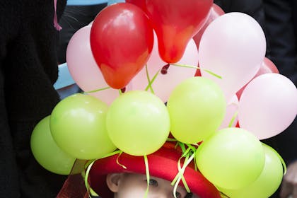 Little boy in balloon hat at Easter parade