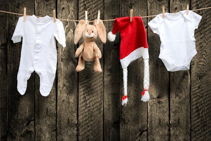 baby clothes pegged to a line with a santa hat and toy bunny