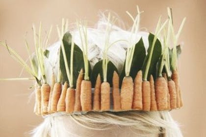 Little boy in hat made from carrots