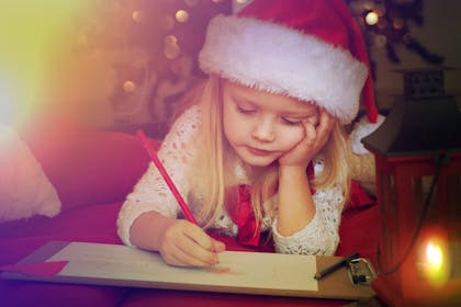 Little girl writing a letter to santa