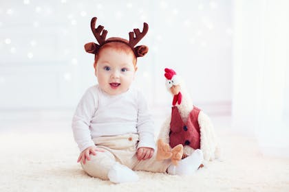 baby and toy reindeer