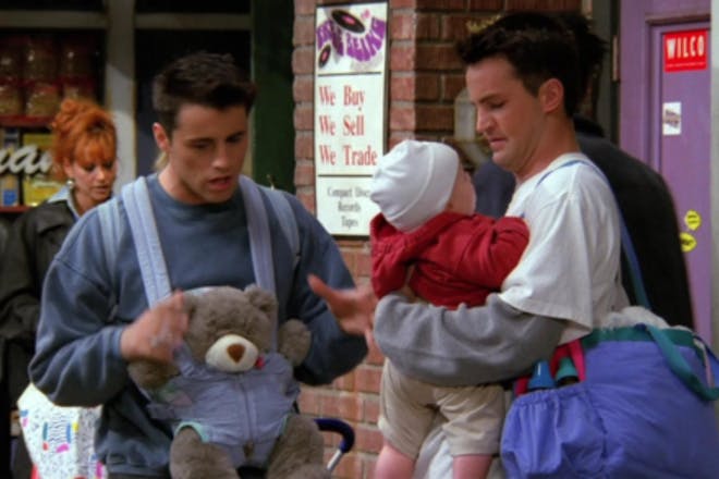 Joey and Chandler from Friends babysitting a baby