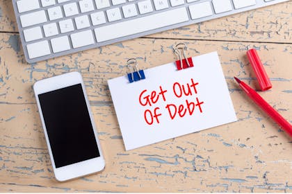 Get out of debt sign with phone and pen