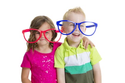 Two children wearing over-sized novelty glasses
