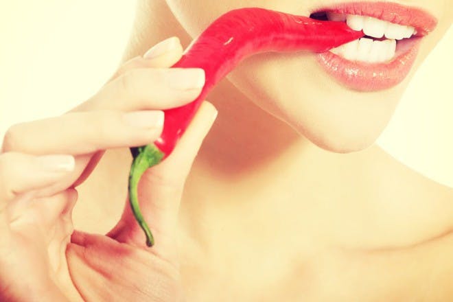 woman eating red chili