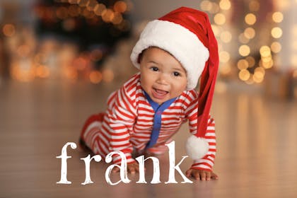 Smiley crawling baby wearing a long Santa hat