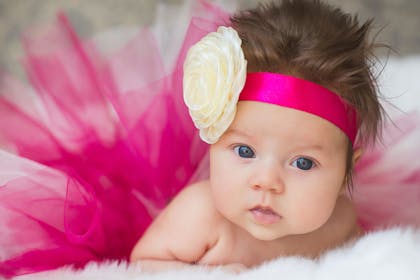 Baby wearing a pink headband and tutu