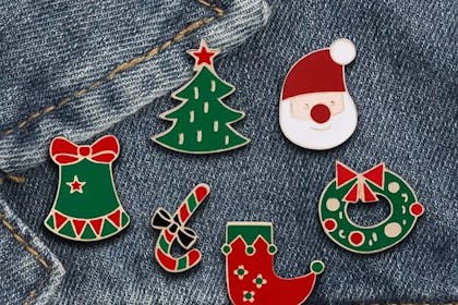 Christmas pin badges pinned to denim jacket