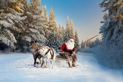 Santa and his reindeer in the snow 