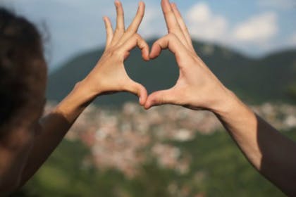 hands making heart shape outdoors