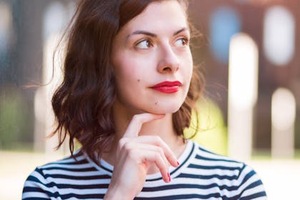 woman thinking wearing striped shirt