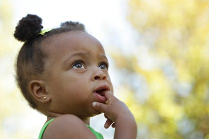 Girl biting finger in green dress