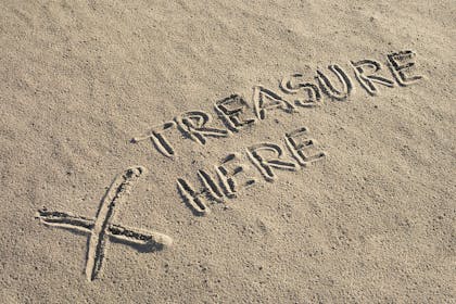 Sand with 'treasure here' written in it