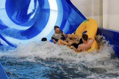 Three people emerge from a water slide at Alpamare Water Park in Scarborough