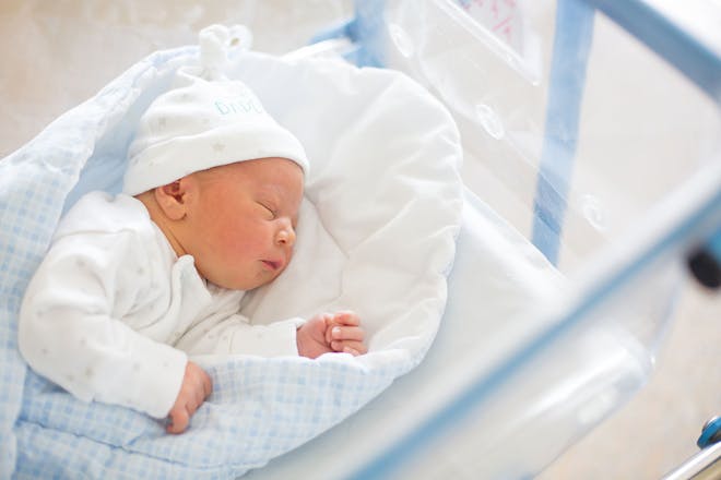 Newborn baby in hospital cot