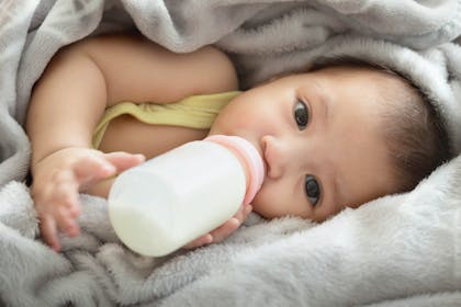 Baby drinking a bottle of milk