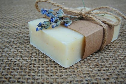 Soap wrapped with paper, string and a sprig of lavender