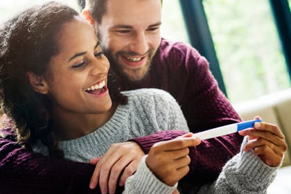 Happy couple looking at pregnancy test