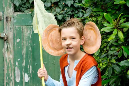 Boy wearing Roald Dahl BFG ears made from paper plates