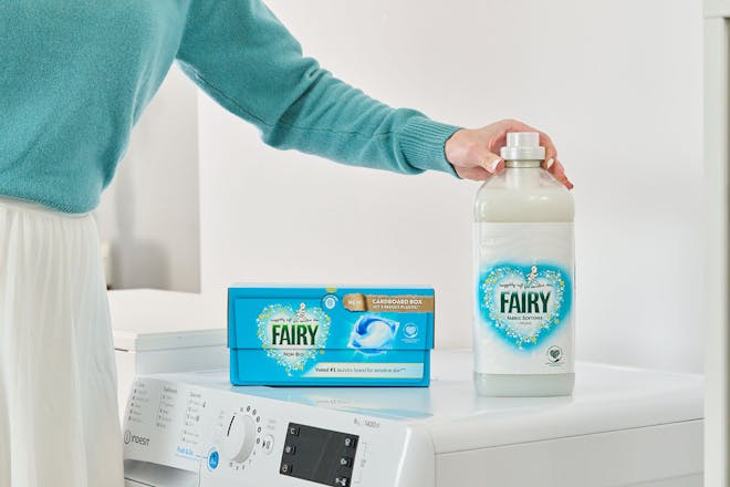 woman reaching for Fairy non bio detergent