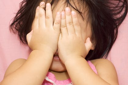 Girl covering eyes playing hide and seek