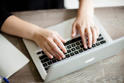 Woman typing on laptop