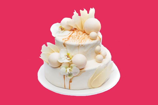 Wedding cake on pink background