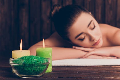 woman relaxing with candles