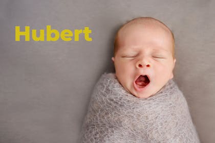 Yawning, swaddled baby. Name Hubert written in text