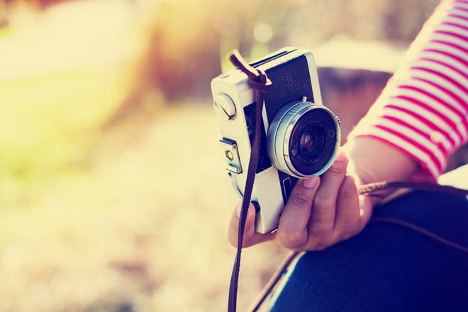 woman holding vintage camera - Photographer