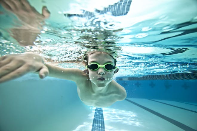 Young boy swimming under water