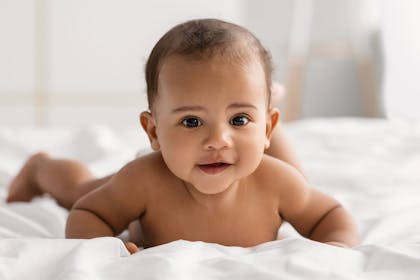 Baby lying on bed