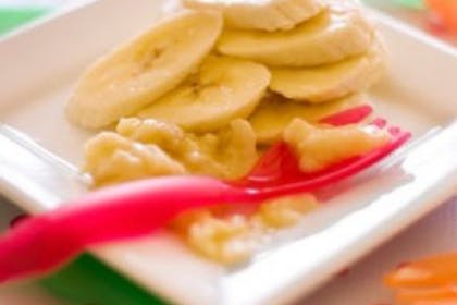 banana slices on small plate with pink fork