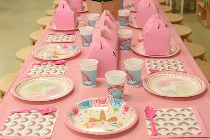 Unicorn themed kids' party table setting