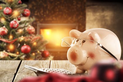 Piggy banks with Christmas tree in background