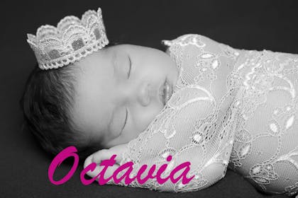 Sleeping baby wearing crown text says Octavia