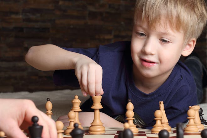 young boy playing chess