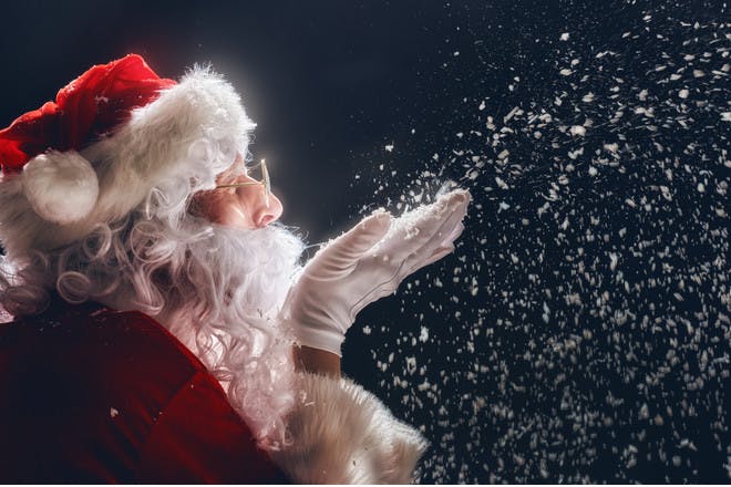 Father Christmas blowing magic dust