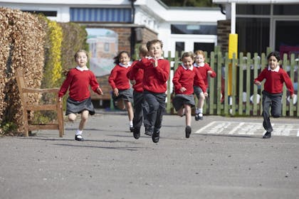 primary school children running in playground