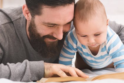 Dad reading book to baby